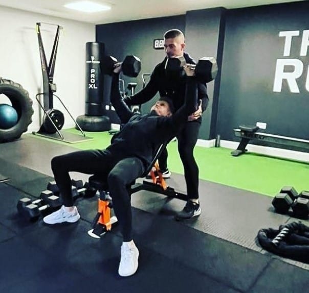 Adam helping a client through a movement