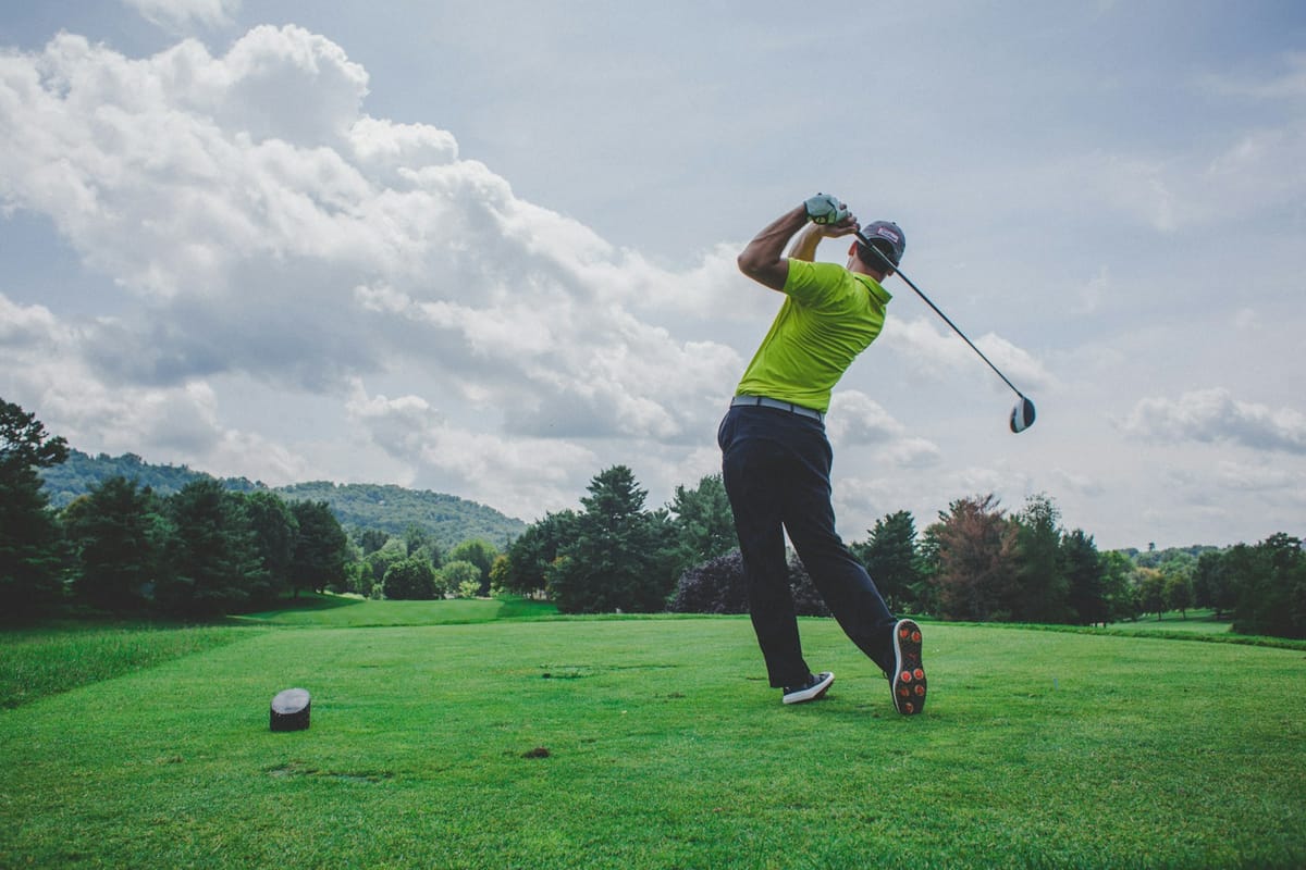 Golfer mid-swing with driver